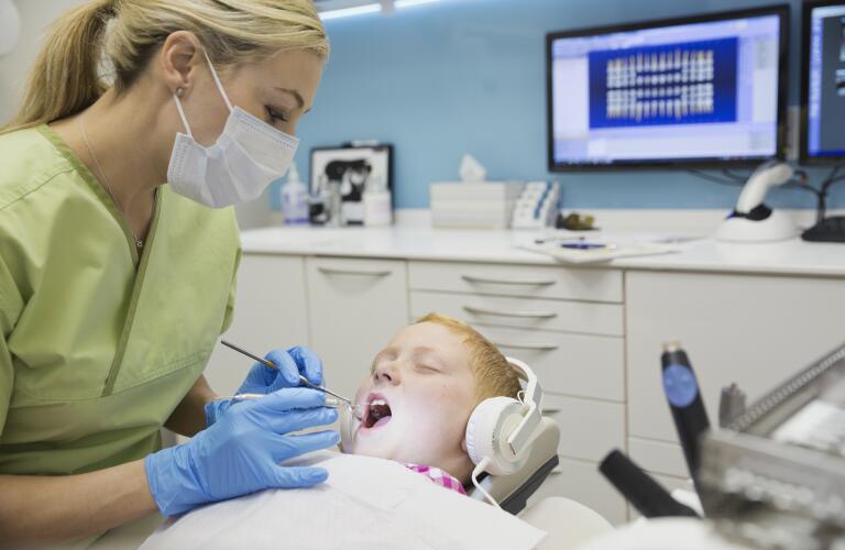 dental hygienist cleaning teeth