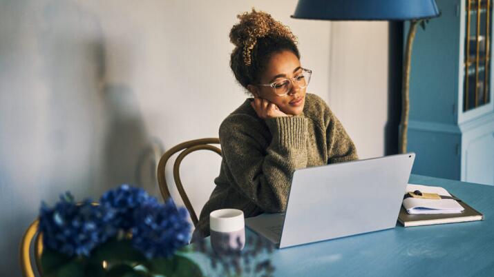 Woman sitting at a table with a laptop