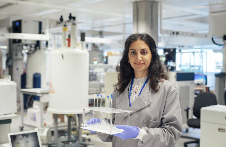 Female researcher holding vials in science lab