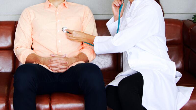 A doctor taking a pulse with a stethoscope