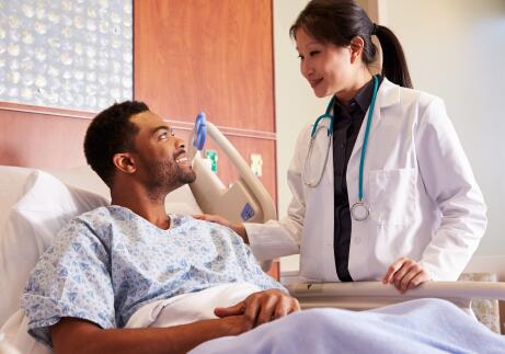 Female doctor talking to male patient