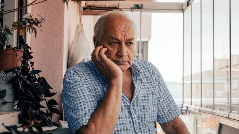 man leaning on his elbow with palm under chin