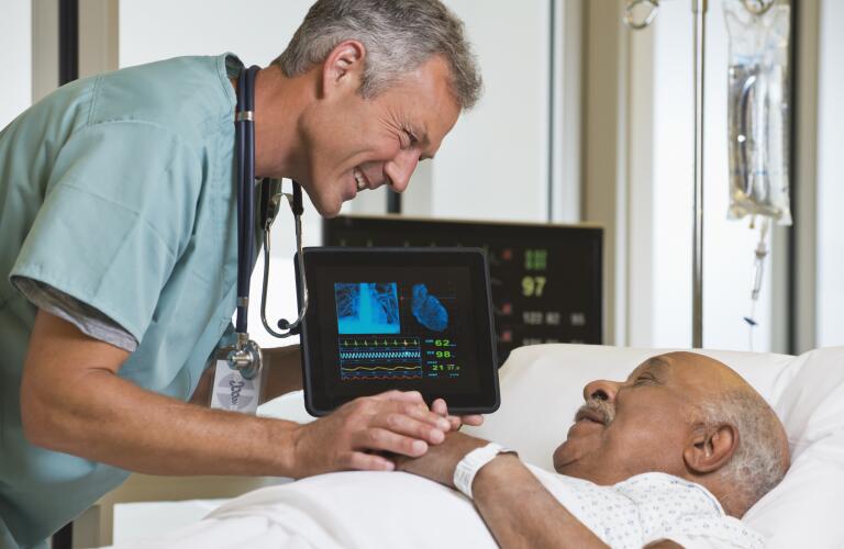 African American man talking to smiling Caucasian surgeon before surgery