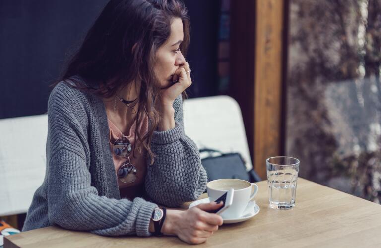 Young brunette woman at care looking off into distance