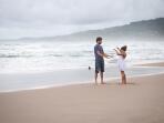 Father and daughter playing on the beach, Barbados