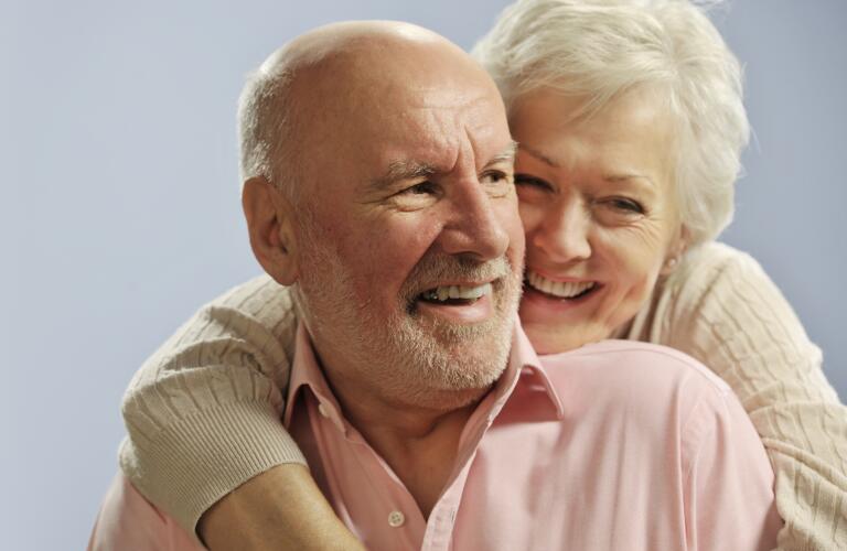 senior couple embracing and smiling
