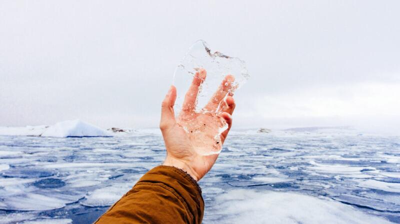 there is a hand holding ice