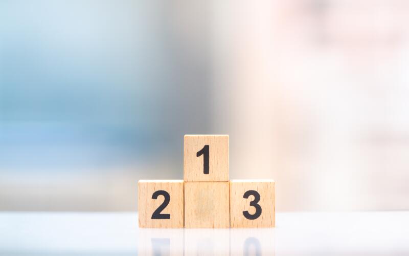 Wooden block winner podium on cityscape background with copy space 
