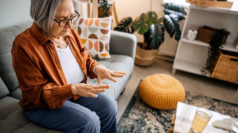 A woman is looking at her hands.