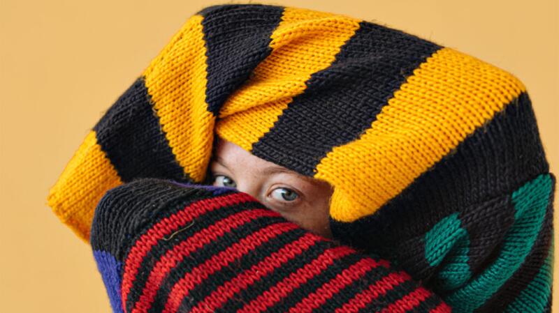 woman wrapped in sweater