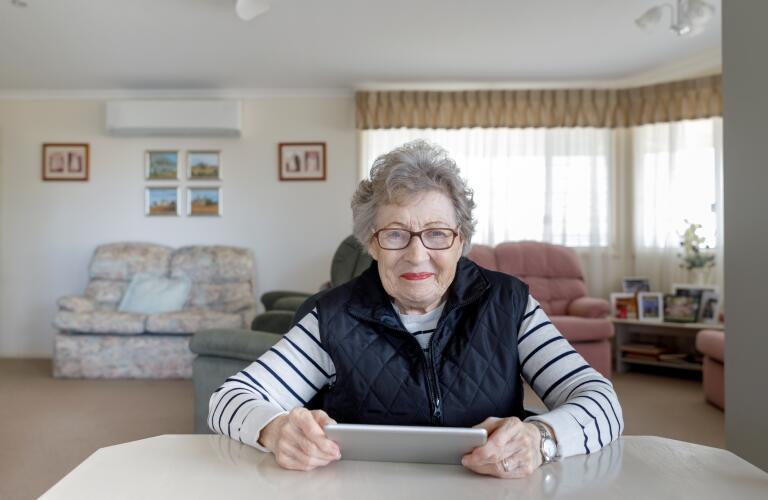 senior woman using digital tablet in her home