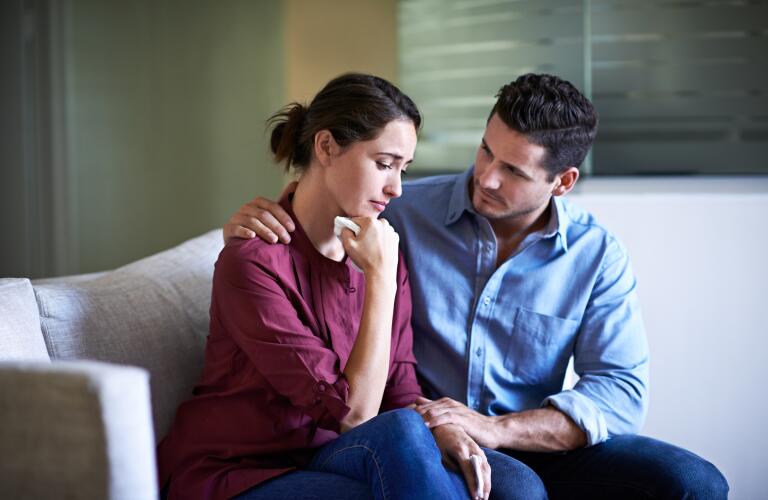 Young Caucasian man comforting crying wife or girlfriend