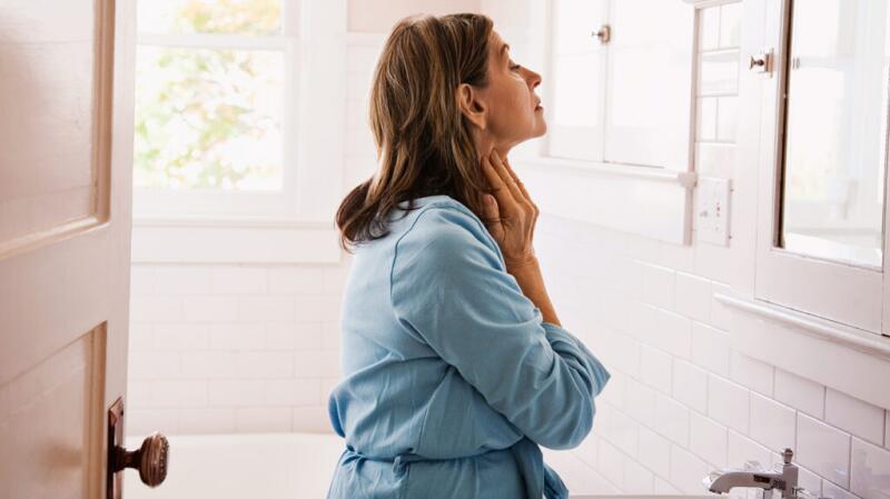 woman touching neck