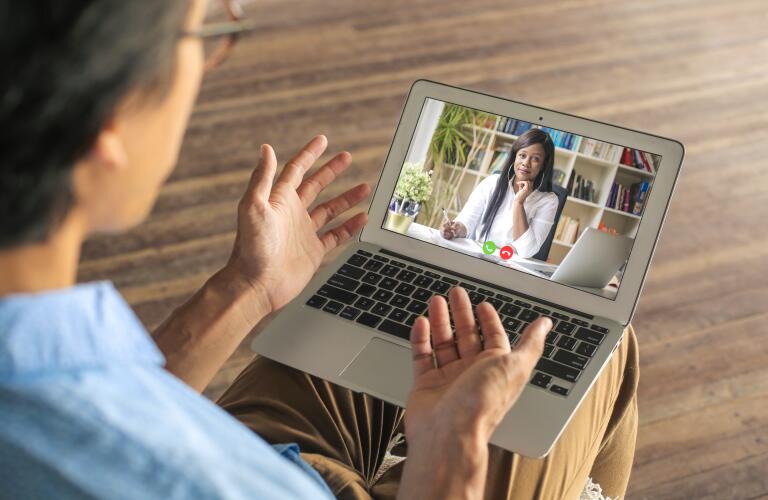 man on a video chat with a therapist or doctor