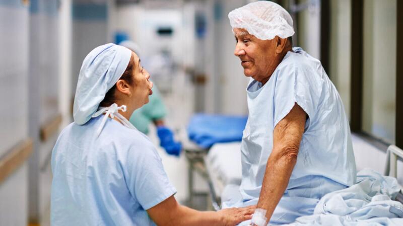 a nurse is talking to a patient with pancreatic cancer