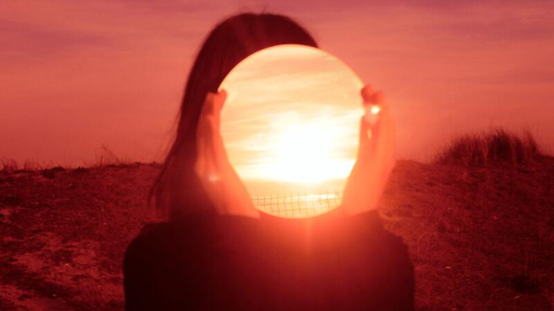 there is a picture of the sun reflected in a mirror