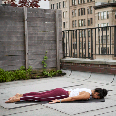 a woman is doing locust pose