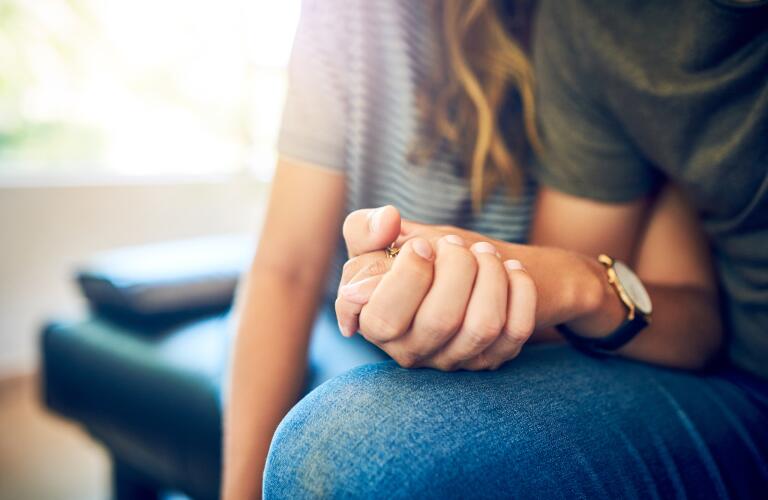 Close-up of Caucasian man and woman holding hands