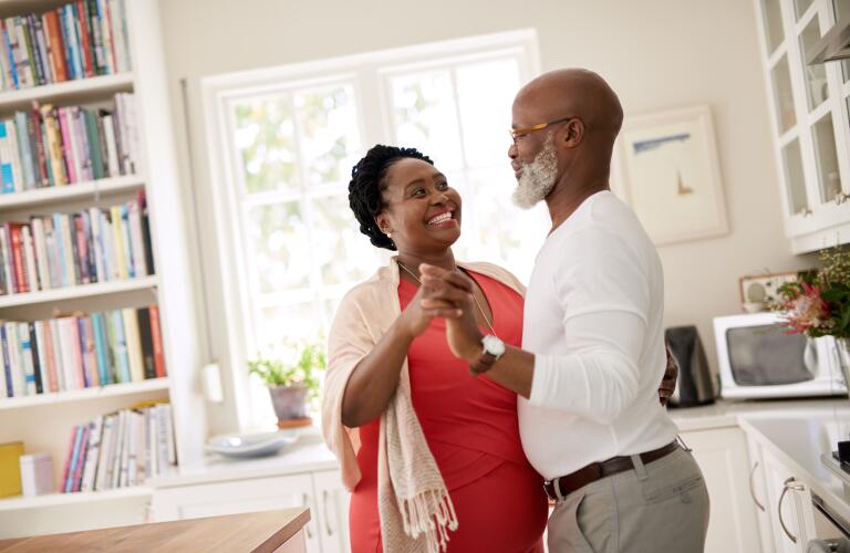 Middle aged couple dancing at home