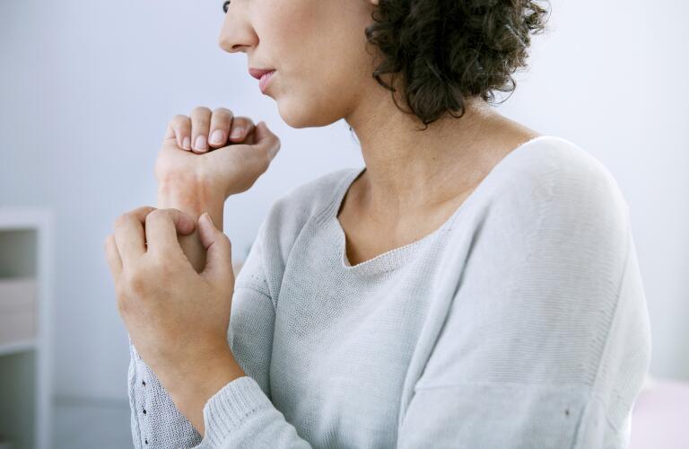 woman itching her arm