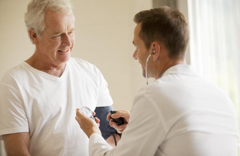 Doctor checking patients blood pressure