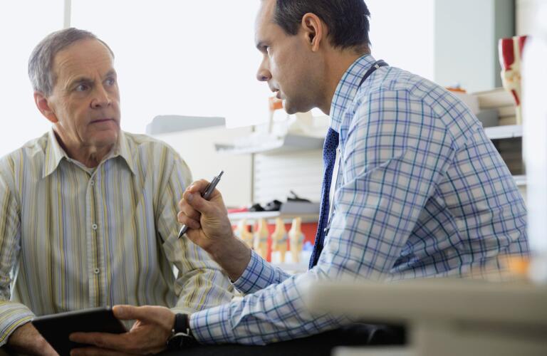 senior patient talking to doctor