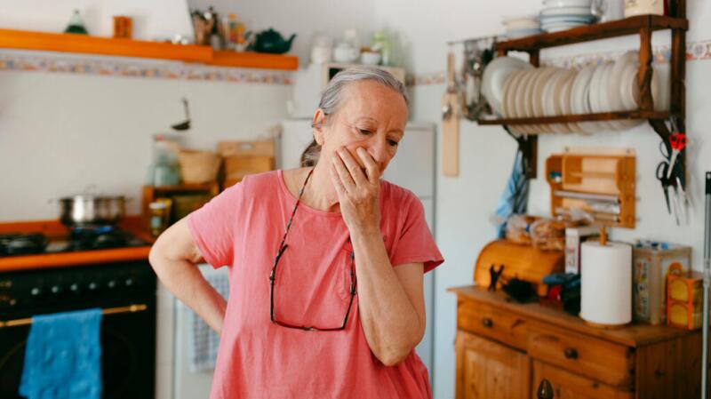 woman with hand over her face