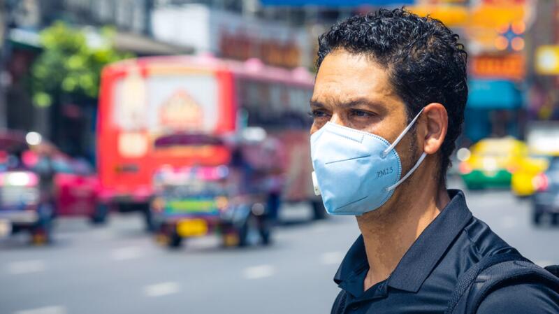 Man wearing a face barrier covering