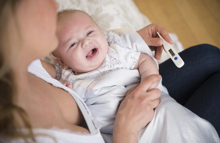 Baby with high temperature and fever