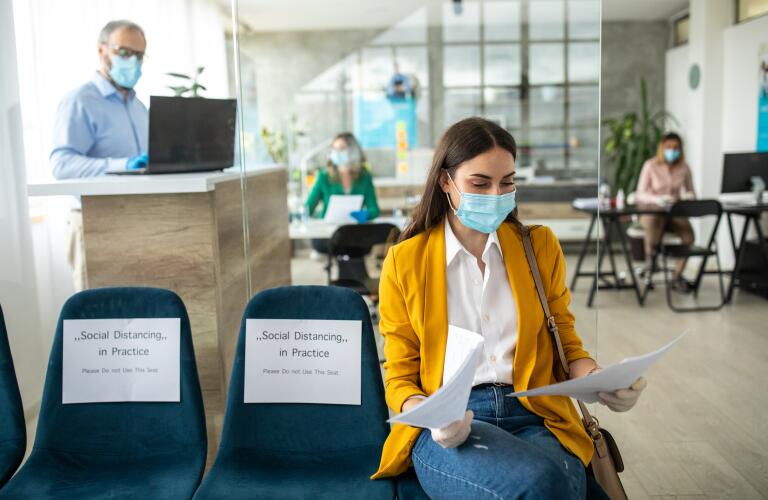 Woman wearing mask in doctor's waiting room