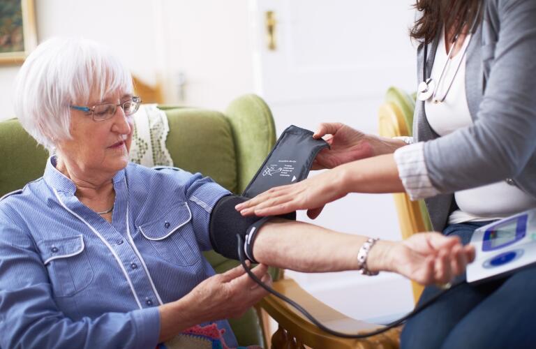 Medic caring for senior woman at home