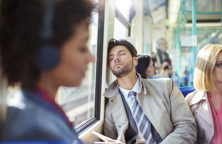 Businessman asleep on train