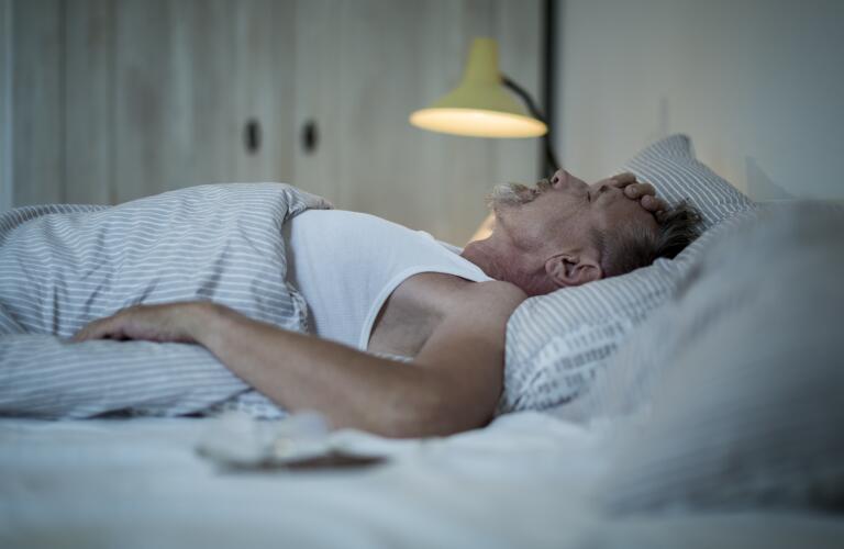 Senior Caucasian man in bed with insomnia