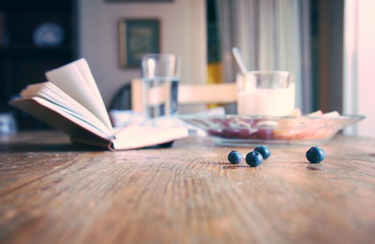 blueberries and journal on breakfast table