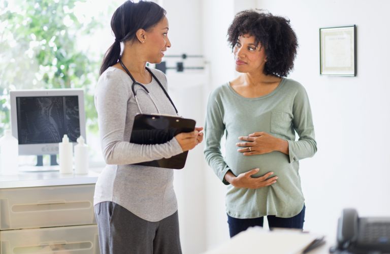 pregnant woman talking to doctor