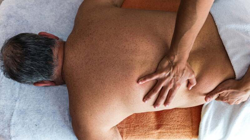 A person is getting a back massage.