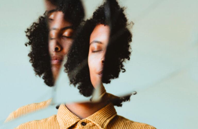 Distorted image of woman looking in the mirror