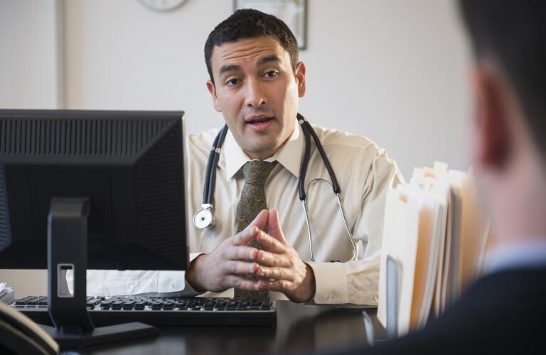 Doctor talking to clients in office