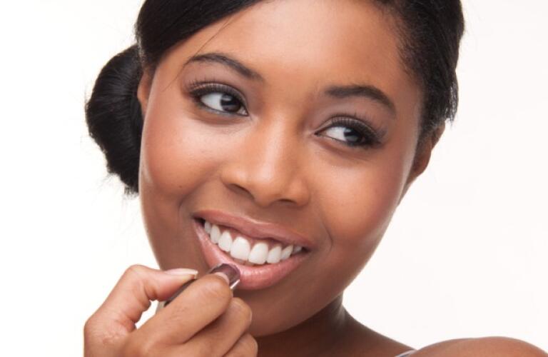 Women putting on lip balm