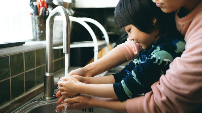 Mother and child washing hands
