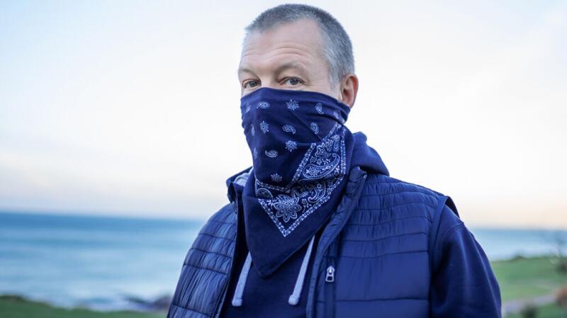 Man wearing a bandana on his face