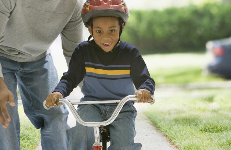 Boy learning to ride bike
