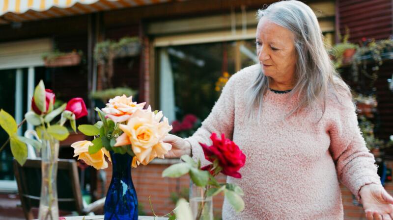 a woman is tending to flowers