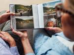 Two older women sitting together, looking through a photo album