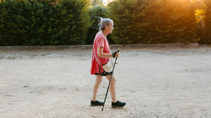 senior woman with walking sticks