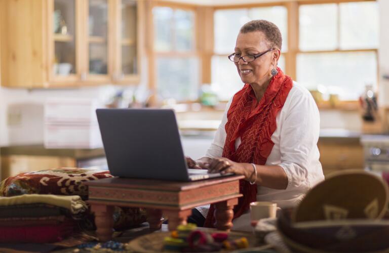 senior woman typing on laptop