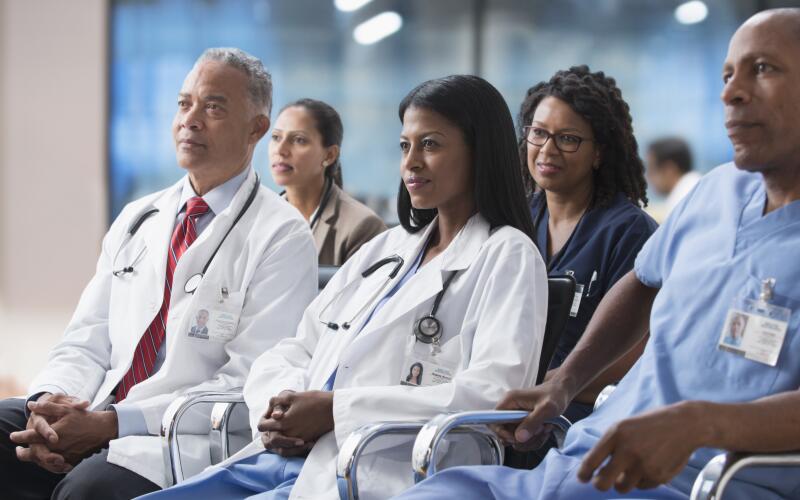 Doctors listening to presentation at conference 