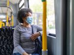 Woman with face mask traveling in train during Covid-19 outbreak 