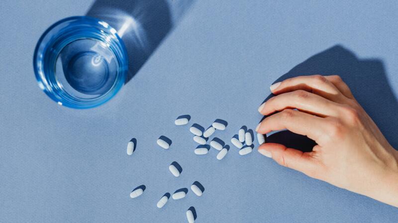 Pills next to a glass of water
