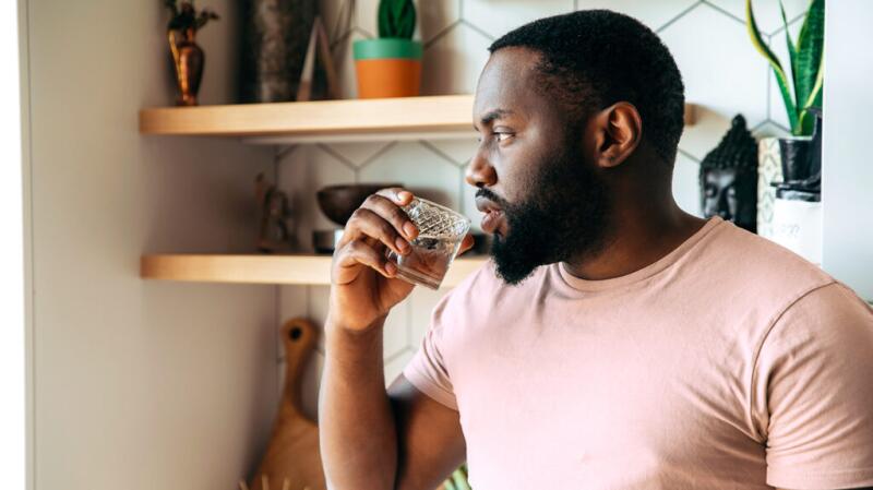 Man drinking water while indoors